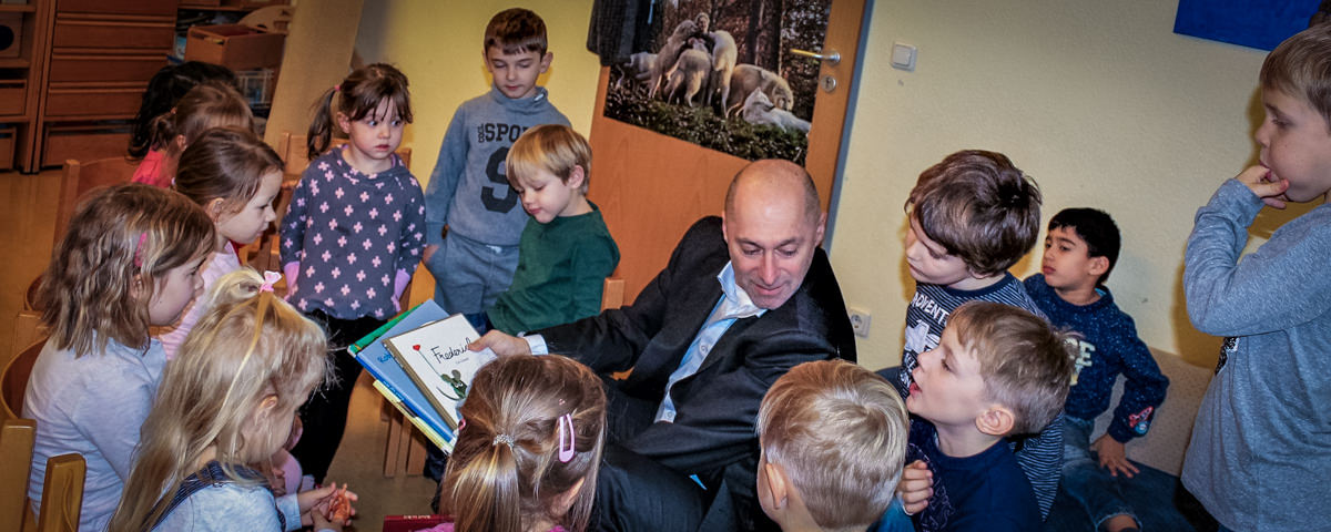 René Rock inmitten von Kindern der Kindertagesstätte Niedernfeld in Seligenstadt